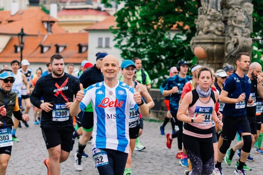 Prague, Czechia - 7th May 2023 - Group athletes runners run marathon in a sunlight