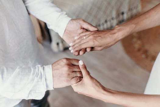 men woman holding hands. Couple holding hands close-up, bride and groom's hands.