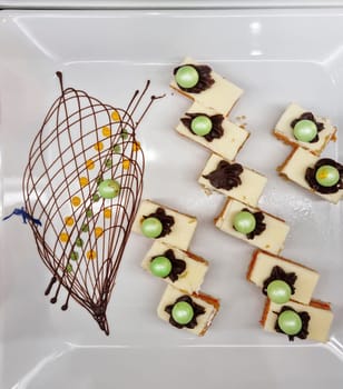 Dessert: delicious cakes on a white ceramic plate. Top view, copy space