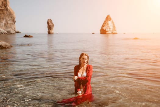 Woman travel sea. Happy tourist taking picture outdoors for memories. Woman traveler looks at the edge of the cliff on the sea bay of mountains, sharing travel adventure journey.