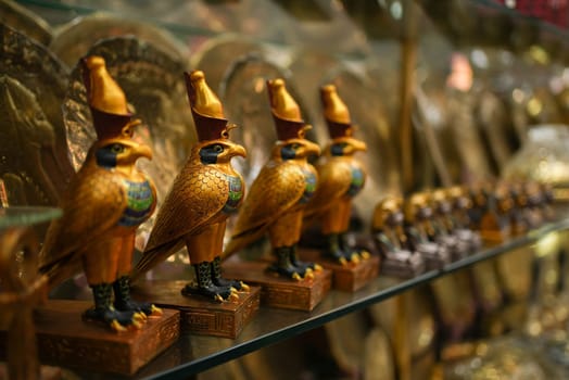 Egyptian souvenir sacred bird figures on a store shelf. High quality photo