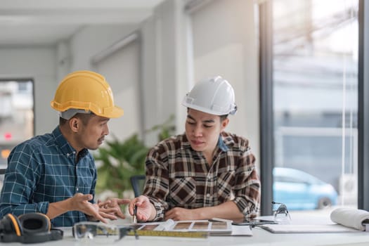 engineer team meeting Use of blueprints, construction drawings and calculations for architectural projects and engineering tools in the workplace technical structure concept.