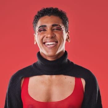 LGBTQ, beauty portrait and black man isolated on red background for creative cosmetics, makeup and queer lifestyle. Young, edgy gen z model or gay person headshot for fashion and face art in studio.