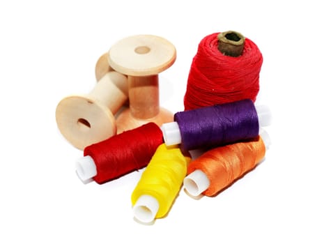 A set of multicolored threads on a white background