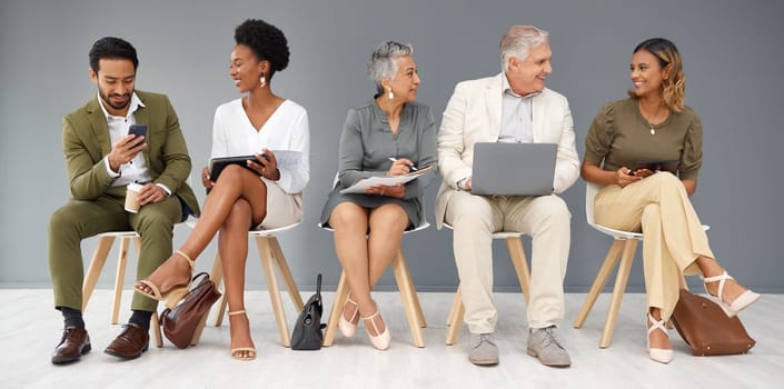 HR, technology and business people waiting in line for a recruitment interview. Hiring, resume or cv with a man and woman employee sitting in a human resources candidate line for opportunity.