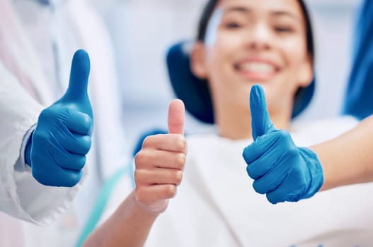 Dentist, thumbs up and happy patient in consultation for teeth whitening, service and dental care. Healthcare, dentistry and hand sign of orthodontist and woman for oral hygiene, wellness or cleaning.