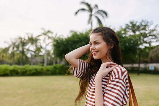 woman hat walk lifestyle girl wellness beautiful t-shirt exercise smiling joy sun quiet active person freedom striped summer happy nature park