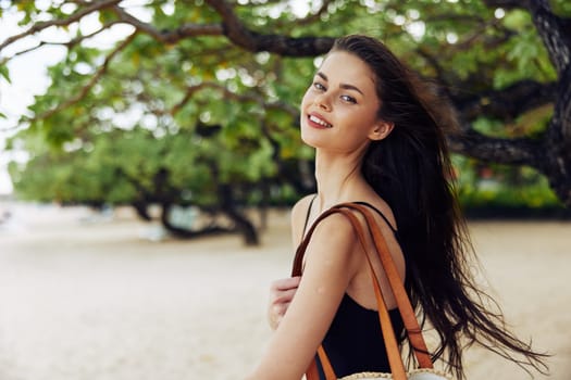 sea woman adult walking peaceful free beach caucasian vacation summer nature dress copy sand coast shore ocean young space sunlight bag smile