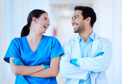 Dentist, nurse laugh and arms crossed with assistant and funny joke at dental office and clinic. Comedy, woman worker and healthcare professional with happiness and laughing in workplace with smile.