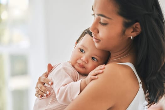 Mother, holding baby and love in a family home for bonding, security and quality time. Woman or mom and girl child relax together in a house for development, trust and support or care on mothers day.