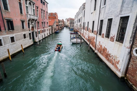 View of one of the canals in Cannareggio district in Venice with a vaporetto landing