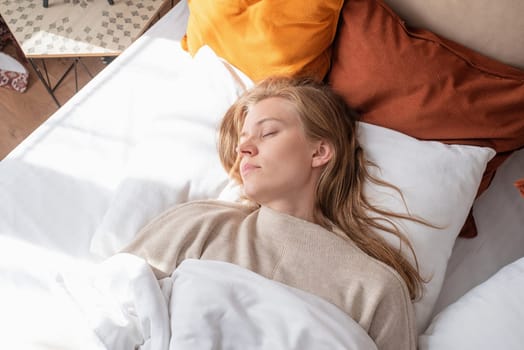 caucasian Woman sleeping at bed at home. young millennial woman sleeping, morning light on the bed