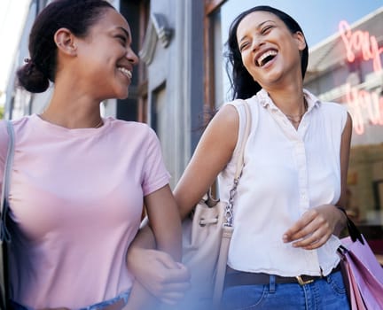 Women, lesbian couple and shopping while holding hands in city, laughing at joke and bonding. Love, sales or discount deals and girls walking with shopping bags after buying clothing in fashion mall