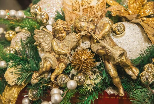 Christmas toys in the form of golden angels on the tree.