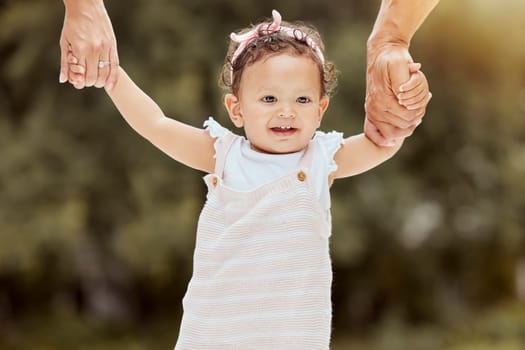 Baby, walking and learning with holding hands with parents in garden, help and girl. Child, walk and teaching to balance, coordination or motor skills for steps with support, care or love in backyard.