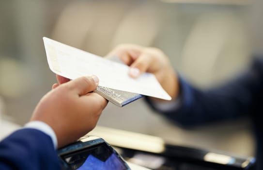 Ticket, airport and person with passport at counter for travel documentation, security ID and airplane journey. Hands, passenger and identity document for check in, booking and flight transportation.