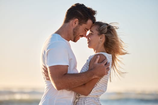 Love, happy hug and couple relax at beach with happy smile, affection and romance on ocean holiday, romantic travel and sunset coastal vacation. Peace, nature and man embrace a woman by Florida sea.
