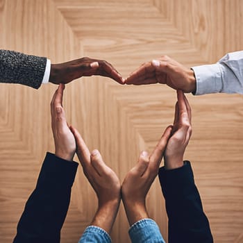 Diversity, heart or hands of business people in support for trust, teamwork or community inclusion in office. Love gesture, above or employees in group collaboration with hope or kindness for charity.