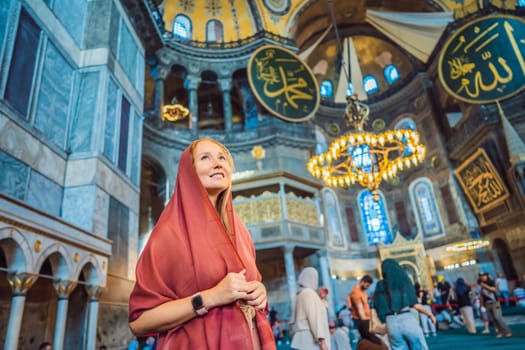 INSCRIPTION - denoting the names of Allah, the Prophet Muhammad, as well as the first 4 caliphs Woman tourist enjoying Hagia Sofia, Ayasofya interior in Istanbul, Turkey, Byzantine architecture, city landmark and architectural world wonder. Turkiye.