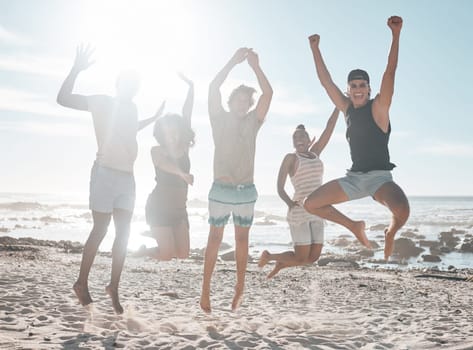 Friends group, jump and diversity at ocean with bonding, love or funny time with black man, women and happy. Young students vacation, spring break and summer sunshine for reunion, excited or exercise.