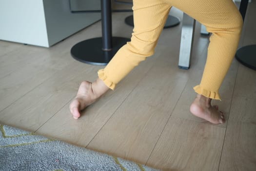 low angle view of A child walking on tiptoes.