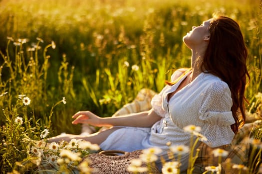 beautiful woman in a light dress lies in the green grass enjoying the sunset. High quality photo