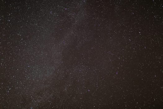 The small dots in the photo are stars from distant galaxies in a clear and cloudless sky at night. The universe in a small slice of the photo.