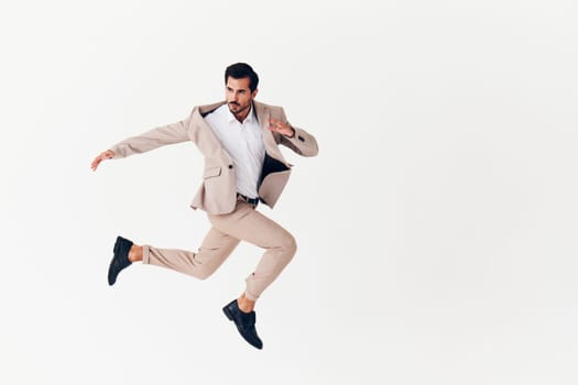 cheerful man copyspace businessman up jumping confident victory business beige model idea winner smiling suit success running person attractive happy sexy