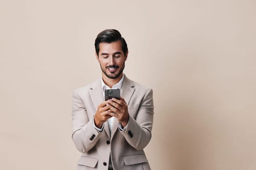 man smartphone suit handsome business application young phone success happy portrait person beard call smile confident internet studio corporate hold lifestyle