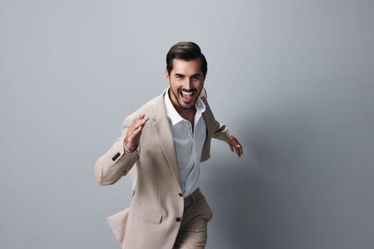 man beige shirt jacket flying tie studio attractive male businessman suit fashion success hand running business sexy office victory winner happy model