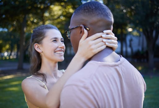 Love, park and smile with an interracial couple bonding outdoor together on a romantic date in nature. Summer, romance and diversity with a man and woman dating outside in a green garden.