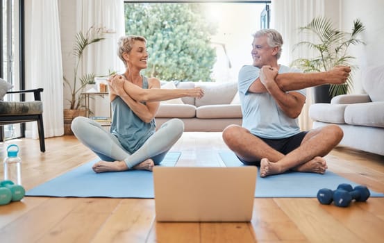 Stretching, happy morning and senior couple training with online workout in the living room of their house. Elderly man and woman doing warm up before fitness exercise with internet yoga on tech.