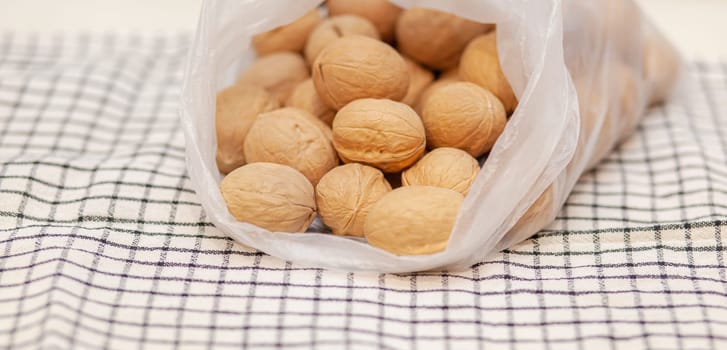 A lot of whole walnuts on a napkin close-up. Healthy, organic and healthy food with a high content of protein and protein.