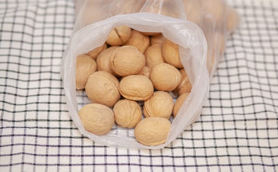 A lot of whole walnuts on a napkin close-up. Healthy, organic and healthy food with a high content of protein and protein.