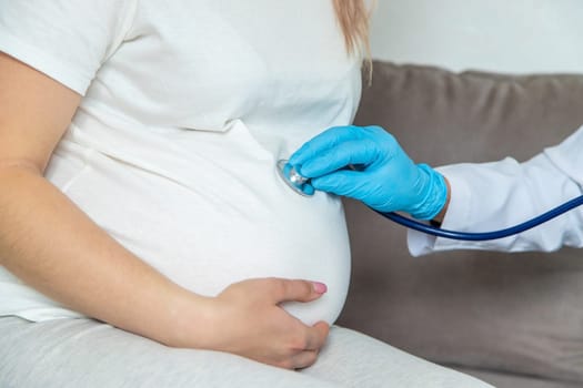 The doctor examines the belly of a pregnant woman. Selective focus. medicine.