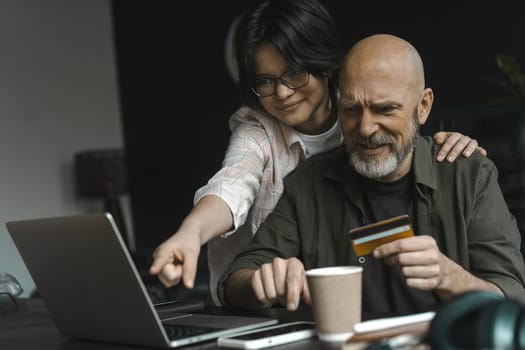 Dad and daughter enjoy online shopping together. Options, purchases, and embracing convenience of online shopping, creating lasting memories as choose and select items from comfort of home. High quality photo