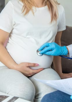 The doctor examines the belly of a pregnant woman. Selective focus. medicine.