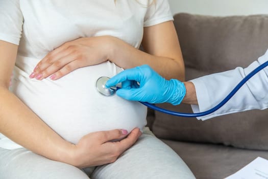 The doctor examines the belly of a pregnant woman. Selective focus. medicine.