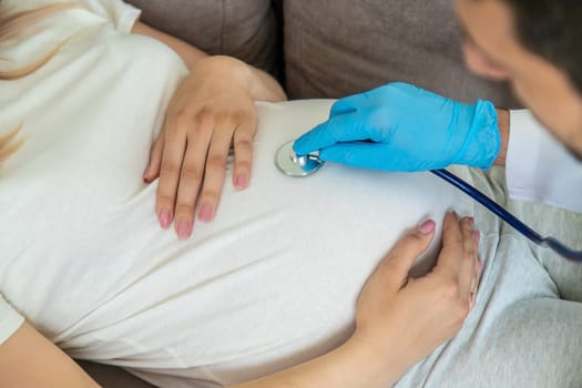 The doctor examines the belly of a pregnant woman. Selective focus. medicine.