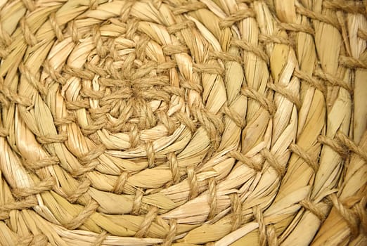 Close-up of Esparto round grass rug, natural fiber background. Weaving from grass and straw, handmade, circle.