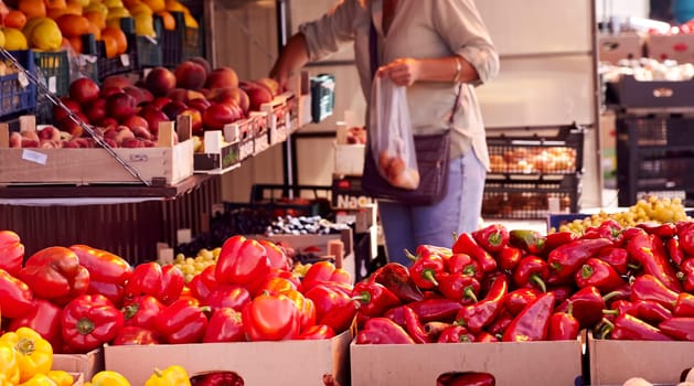 Red chili peppers with vegetables in the market. Tomatoes and peppers are selected by the buyer at the market.