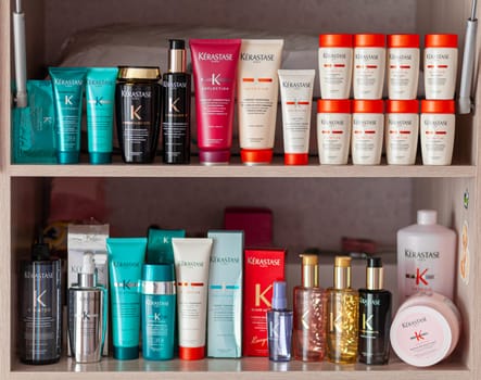Many different jars of shampoo, hair care balms on the shelf. Jars and tubes stand in a row