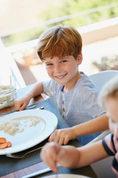 What a yummy meal. Portrait of a little boy enjoying a meal with his family at home