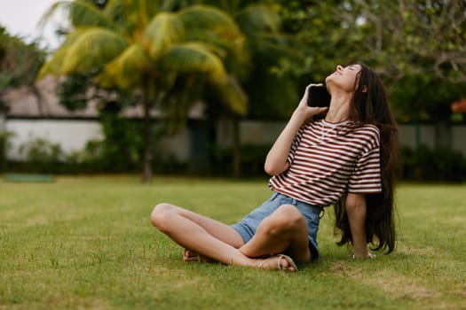 park woman summer spring lifestyle happy caucasian seasonal call talking network cellphone tree grass smiling cell nature smart adult phone palm blogger