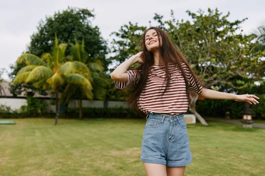 long woman park summer freedom smiling beauty t-shirt face lifestyle walk fashion day sunny carefree beautiful bag hair enjoy hipster nature portrait