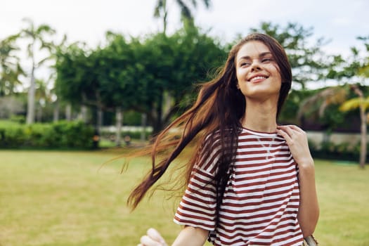 meditation woman hair striped outdoor smiling walk grass wellness quiet long park happy summer lifestyle person nature relax t-shirt beautiful freedom girl