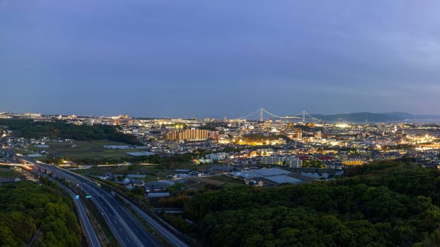 Quiet highway by lights from city and suspension bridge in twilight. High quality photo