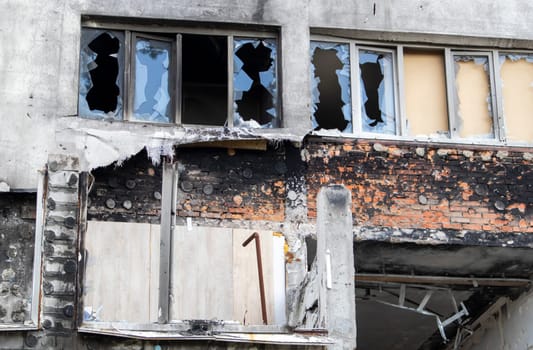 Residential buildings, windows and balconies were damaged by the blast and shrapnel from artillery shelling. The destruction of the city by military operations, the consequences of the war