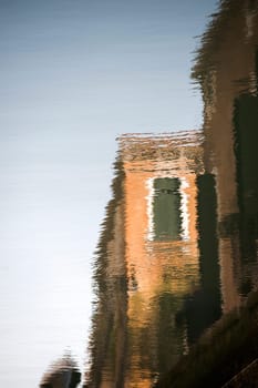 The houses of Venice reflected on the water of a canal