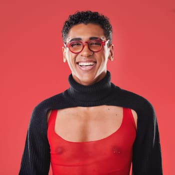 LGBTQ, queer and portrait of a gay man with unique fashion and style isolated against a studio red background. Transgender, homosexual and trendy nonbinary and gen z person happy in clothes.